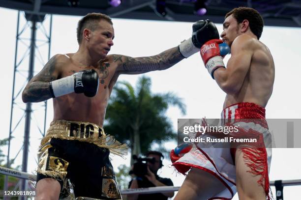 Rhys Evans and Jalen Tait trade punches during their lightweight title bout at Southbank Plaza on October 15, 2022 in Brisbane, Australia.