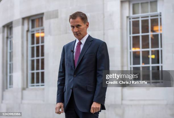 Chancellor of the Exchequer, Jeremy Hunt, prepares himself before being interviewed outside BBC Broadcasting House on October 15, 2022 in London,...