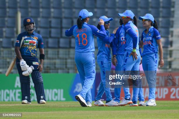 India's players celebrate after the dismissal of Sri Lanka's captain Chamari Athapaththu during the women's Asia Cup final cricket match between...