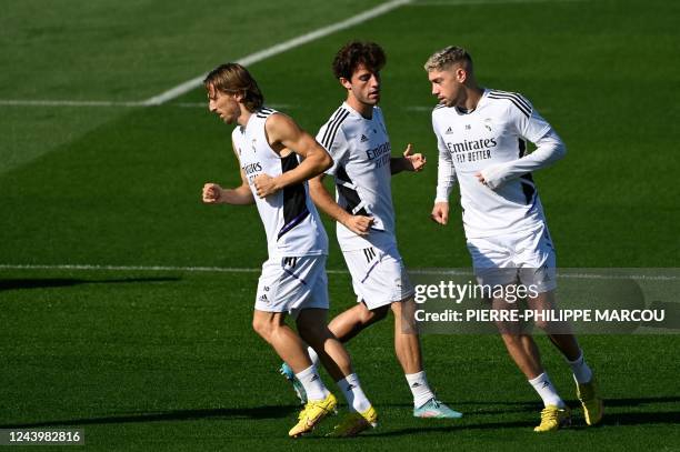 Real Madrid's Croatian midfielder Luka Modric , Real Madrid's Spanish defender Alvaro Odriozola and Real Madrid's Uruguayan midfielder Federico...