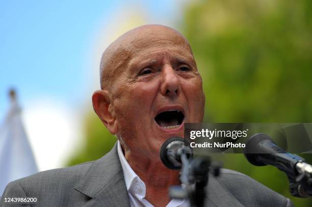 Ahmed Néjib Chebbi head of the Salvation Front speaks with Islamist Ennahda party supporters wave the national flag during a demonstration against...