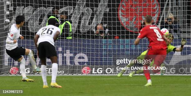 Frankfurt's Japanese midfielder Daichi Kamada scores the 1-0 goal during the German first division Bundesliga football match between Eintracht...