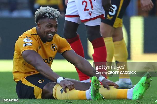 Wolverhampton Wanderers' Spanish midfielder Adama Traore smiles after being fouled during the English Premier League football match between...