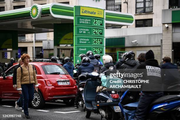 Motorists wait in lines at a gas station in Paris on October 15, 2022. - Striking French refinery workers vowed on October 14, 2022 to pursue...