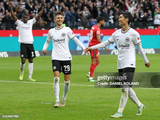 Frankfurt's Japanese midfielder Daichi Kamada celebrates scoring the 4-1 goal with team mates during the German first division Bundesliga football...