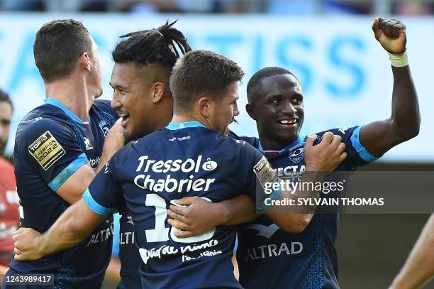 Montpellier's Australian hooker Brandon Paenga-Amosa celebrates with Montpellier's French-Cameroonian wing Gabriel N'gandebe after scoring a try...