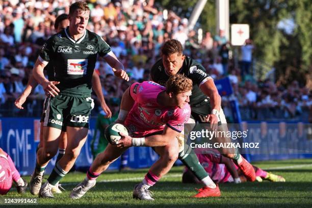 Stade Francais' South African scrum-half James Hall passes the ball during the French Top14 rugby union match between Section Paloise Bearn Pyrenees...