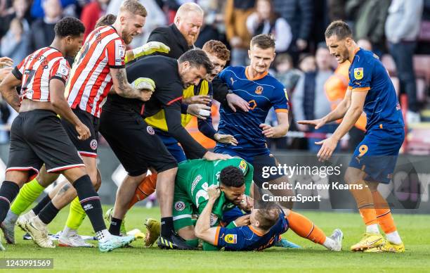 Blackpool's Shayne Lavery is taken to ground by Sheffield United's goalkeeper Wes Foderingham during the Sky Bet Championship between Sheffield...