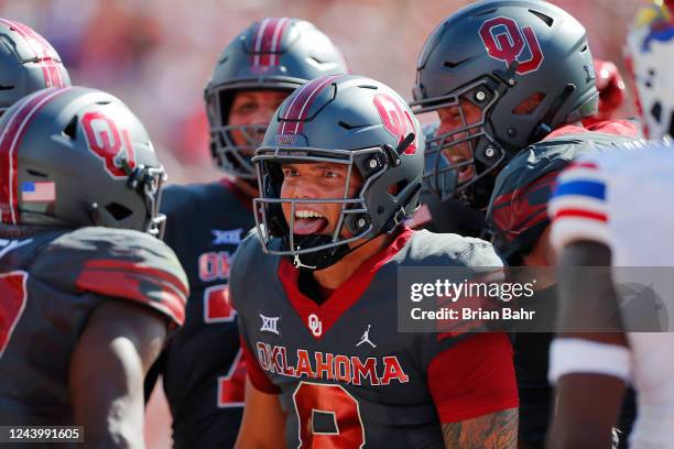 Quarterback Dillon Gabriel of the Oklahoma Sooners celebrates a touchdown by running back Eric Gray against the Kansas Jayhawks late in the second...