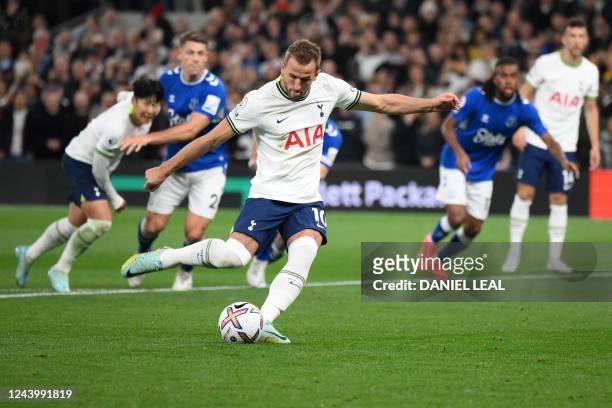 Tottenham Hotspur's English striker Harry Kane shoots a penalty kick and scores his team first goal during the English Premier League football match...