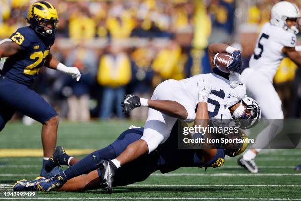 Michigan Wolverines linebacker Mike Morris tackles Penn State Nittany Lions running back Nicholas Singleton for a loss of yardage during a college...