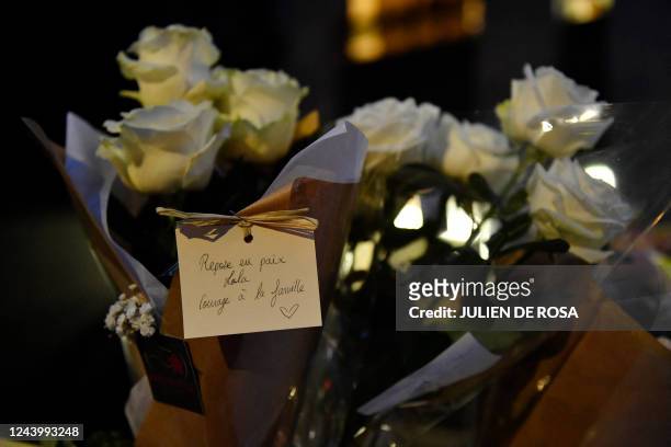 This photograph shows a bouquet of flowers and a note reading "Rest in peace Lola, thoughts to the family" at the foot of the building of the 12...