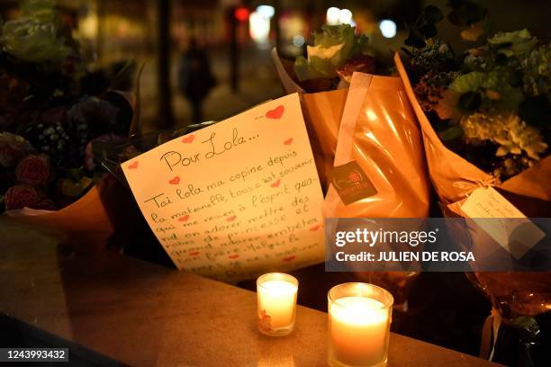 This photograph shows flowers and messages at the foot of the building of the 12 year-old schoolgirl who was found dead a day before in a trunk in...