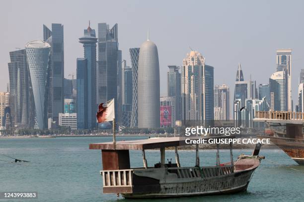 Picture taken on October 15 shows a view of the skyline of the Qatari capital Doha and traditional dhows in the harbour ahead of the FIFA 2022...