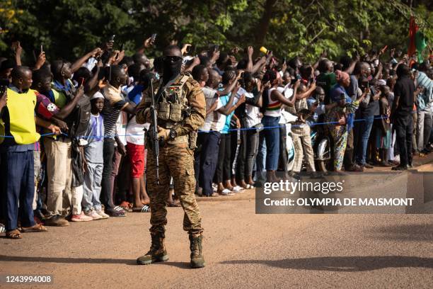 Bystanders greet Burkina Faso's new president during the 35th anniversary of Thomas Sankaras assassination, in Ouagadougou, on October 15, 2022. -...