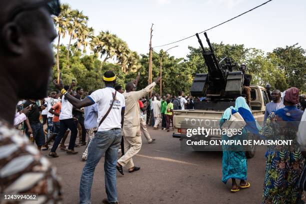 People cheer at the army during the ceremony for the 35th anniversary of Thomas Sankaras assassination, in Ouagadougou, on October 15, 2022. -...