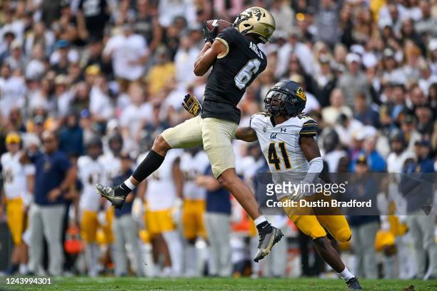 Wide receiver Daniel Arias of the Colorado Buffaloes catches a pass for a 41-yard gain and first down under coverage by cornerback Isaiah Young of...