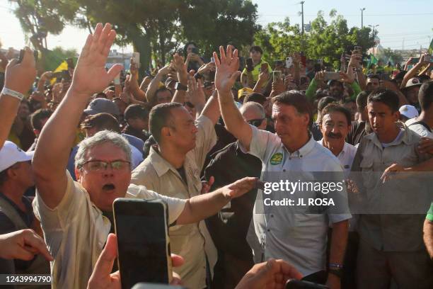 Brazilian President and presidential candidate Jair Bolsonaro greets supporters during a rally in Fortaleza, Ceara state, Brazil on October 15, 2022....