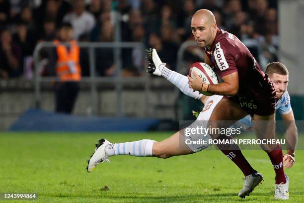 Bordeaux-Begles' French scrum-half Maxime Lucu is tackled by Racing92's Scottish fly-half Finn Russell during the French Top14 rugby union match...