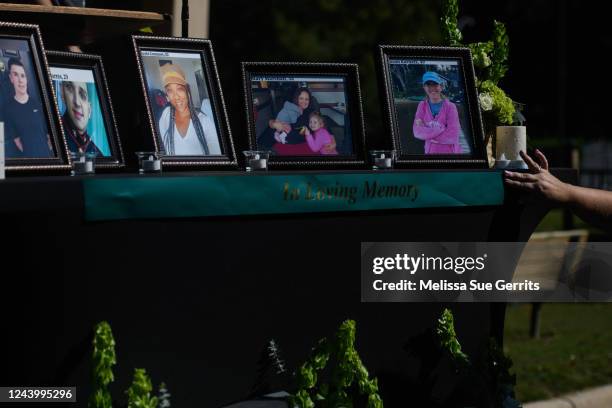 People set up a memorial table with images of the victims of a shooting in the Hedignham neighborhood on October 15, 2022 in Raleigh, North Carolina....