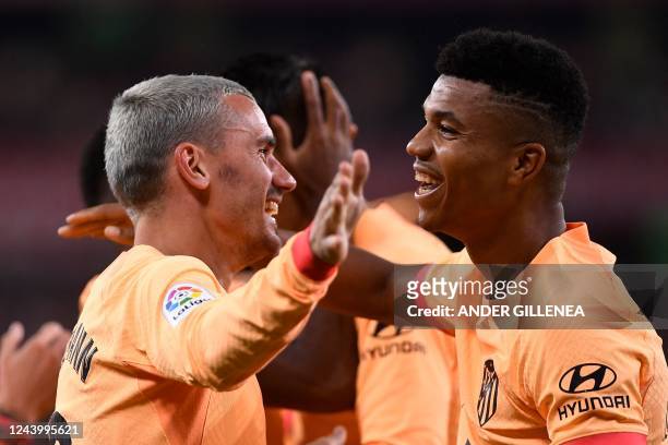 Atletico Madrid's French forward Antoine Griezmann celebrates with Atletico Madrid's Mozambican defender Reinildo Mandava scoring his team's first...
