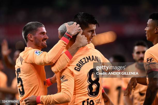 Atletico Madrid's French forward Antoine Griezmann celebrates with Atletico Madrid's Argentinian midfielder Rodrigo De Paul and Atletico Madrid's...