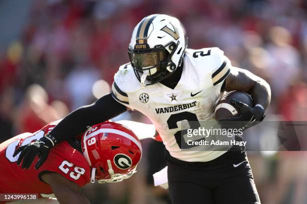 Ray Davis of the Vanderbilt Commodores is tackled by Christopher Smith of the Georgia Bulldogs during the first quarter at Sanford Stadium on October...