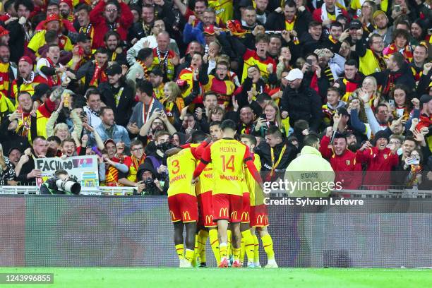 Players of RC Lens celebrate after scoring 1st goal during the Ligue 1 Uber Eats match between Lens and Montpellier at Stade Felix Bollaert on...