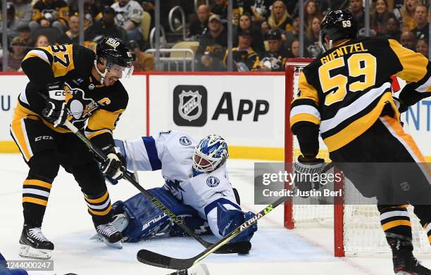 Sidney Crosby of the Pittsburgh Penguins scores a goal past Brian Elliott of the Tampa Bay Lightning in the first period during the game at PPG...