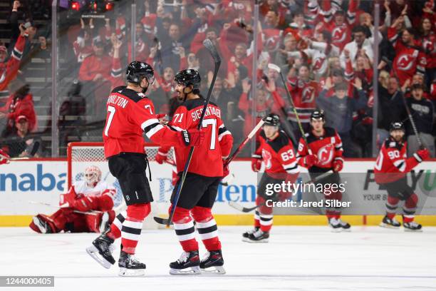 Dougie Hamilton of the New Jersey Devils celebrates with teammates after scoring a goal in the first period against the Detroit Red Wings at the...