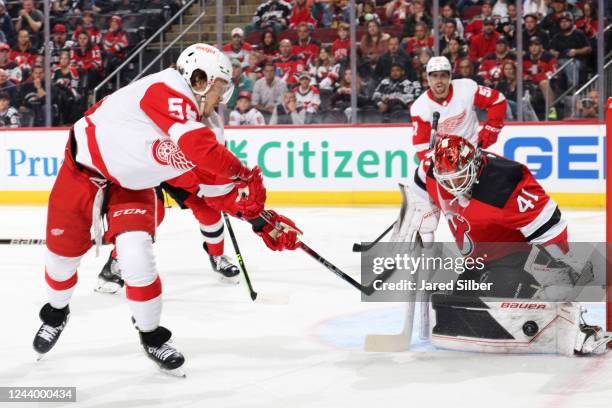 Vivek Vanecek of the New Jersey Devils makes a save against Tyler Bertuzzi of the Detroit Red Wings at the Prudential Center during the home opener...