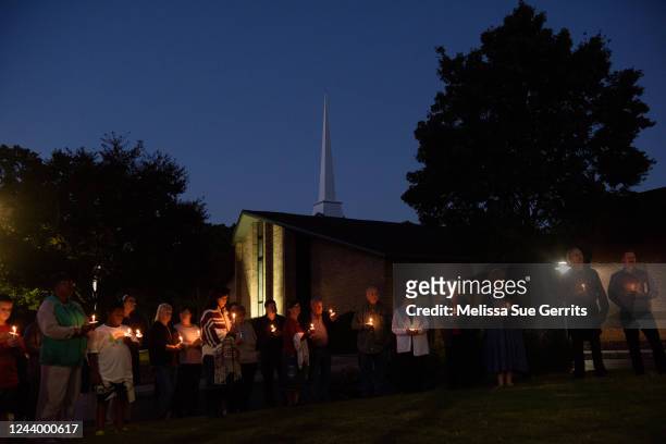 Mourners gather at Beacon Baptist Church for a candle light vigil on October 15, 2022 in Raleigh, North Carolina. A crowd of people joined to honor...