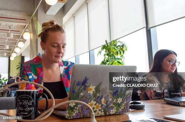Kirsty Hall, a digital nomad from Scotland who lives in Mexico but works remotely with a start-up in San Francisco, in the US, works on her laptop at...