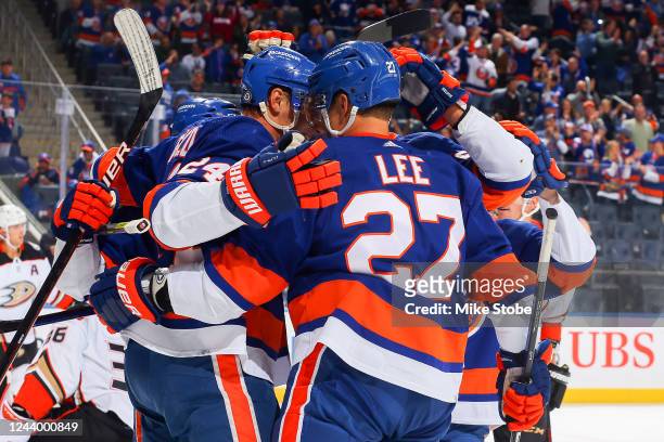Scott Mayfield of the New York Islanders is congratulated by his teammates after scoring a goal against the Anaheim Ducks during the first period at...