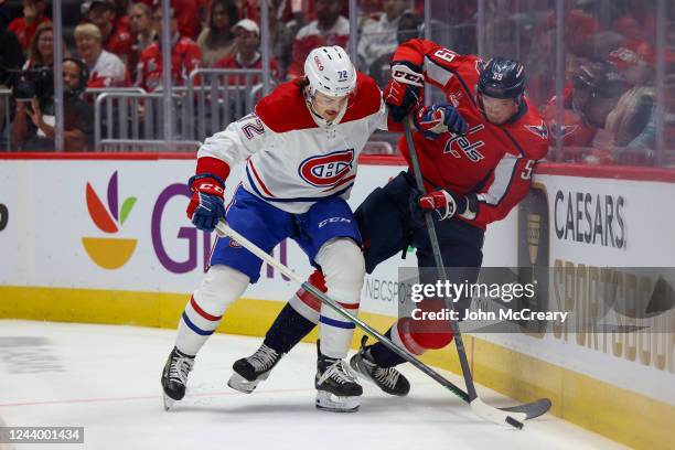 Arber Xhekaj of the Montreal Canadiens makes a hit on Aliaksei Protas of the Washington Capitals during a game at Capital One Arena on October 15,...