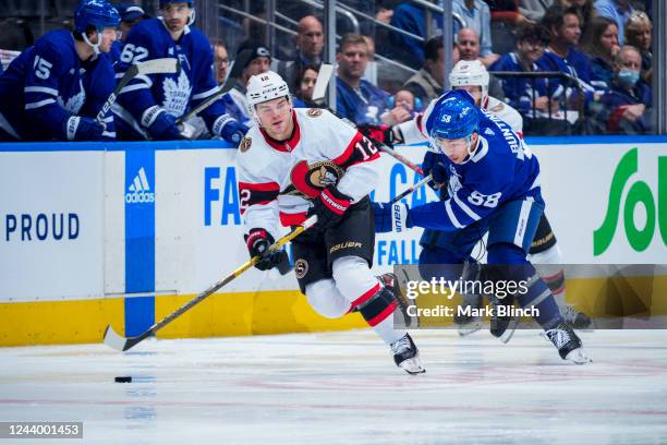 Alex DeBrincat of the Ottawa Senators plays the puck against the Toronto Maple Leafs during the second period at the Scotiabank Arena on October 15,...