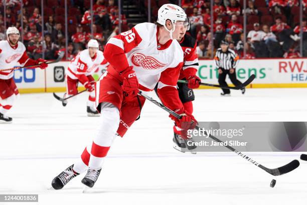 Elmer Soderblom of the Detroit Red Wings skates with the puck against the New Jersey Devils at the Prudential Center on October 15, 2022 in Newark,...