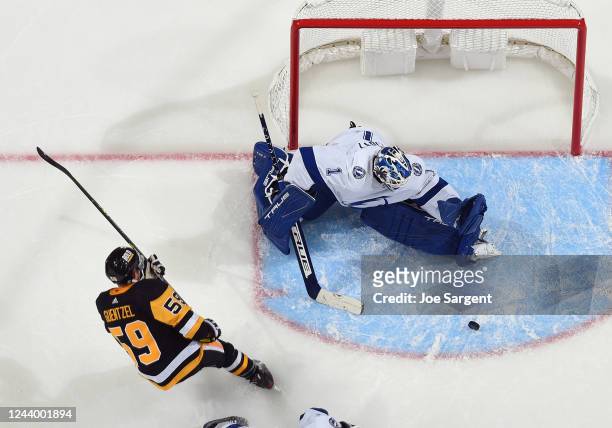 Brian Elliott of the Tampa Bay Lightning makes a save against Jake Guentzel of the Pittsburgh Penguins during the game at PPG PAINTS Arena on October...