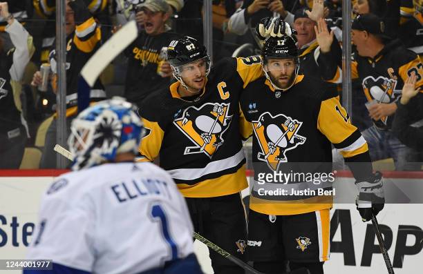 Bryan Rust of the Pittsburgh Penguins celebrates with Sidney Crosby after scoring a goal in the third period during the game against the Tampa Bay...