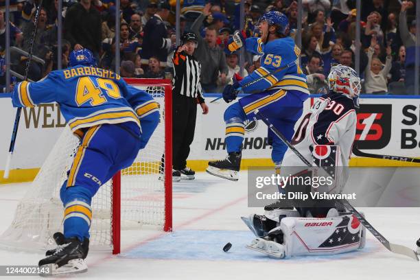 Jake Neighbours of the St. Louis Blues celebrates after scoring a goal against Elvis Merzlikins of the Columbus Blue Jackets in the third period at...