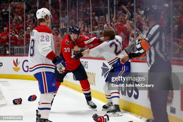 Anthony Mantha of the Washington Capitals engages in a fight with Kaiden Guhle of the Montreal Canadiens during a game at Capital One Arena on...