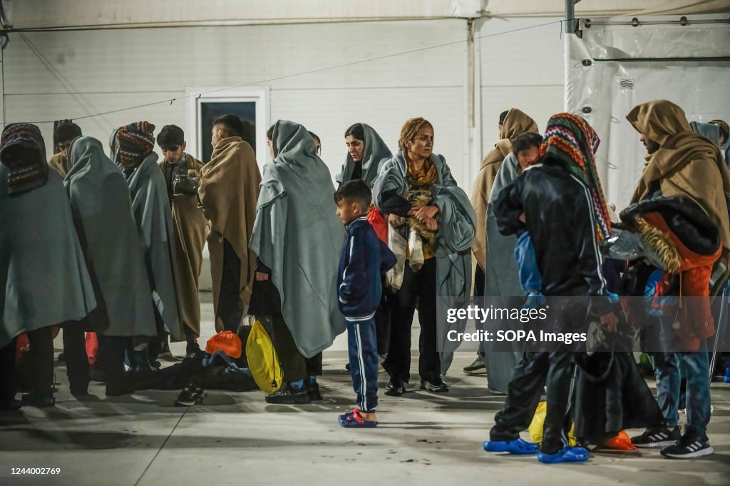 Migrants seen sheltering in the first aid camp...