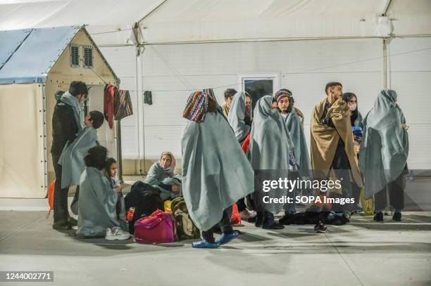 Migrants seen sheltering in the first aid camp. 64 irregular migrants, mainly from Afghanistan, Iran, Syria and Iraq, were helped by the Italian...