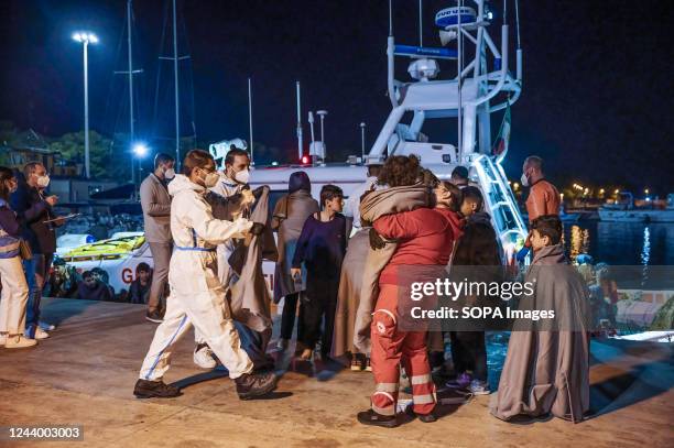 Members of the Red Cross assist migrants as they disembark from the boat. 64 irregular migrants, mainly from Afghanistan, Iran, Syria and Iraq, were...