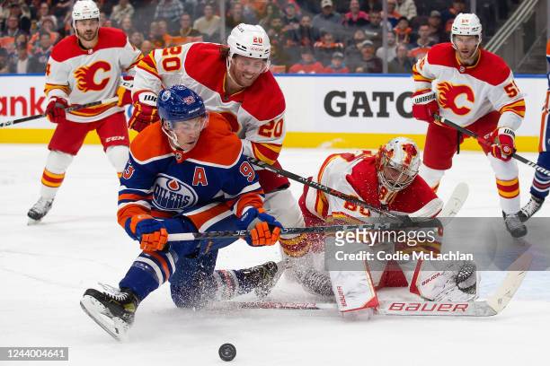Ryan Nugent-Hopkins of the Edmonton Oilers battles against Blake Coleman and goaltender Dan Vladar of the Calgary Flames during the second period at...