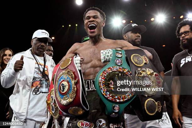 Devin Haney of the US celebrates defeating George Kambosos of Australia to become the undisputed lightweight boxing world champion in Melbourne on...