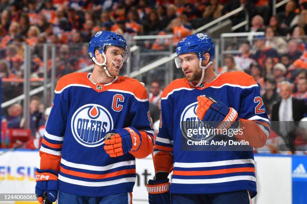 Connor McDavid and Leon Draisaitl of the Edmonton Oilers discuss the play during the game against the Calgary Flames on October 15, 2022 at Rogers...
