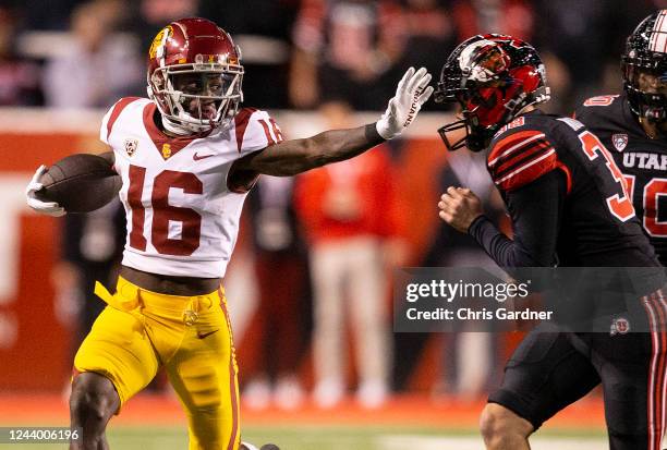 Tahj Washington of the USC Trojans rushes the ball agaisnt Brock Nowatzke of the Utah Utes during the second half of their game October 15, 2022...