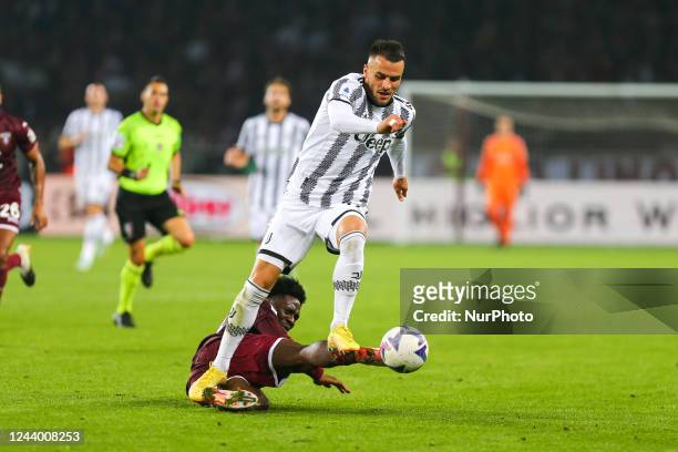 Filip Kostic of Juventus FC and Ola Aina of Torino FC compete for the ball during the Serie A match between Torino FC and Juventus FC on October 15,...