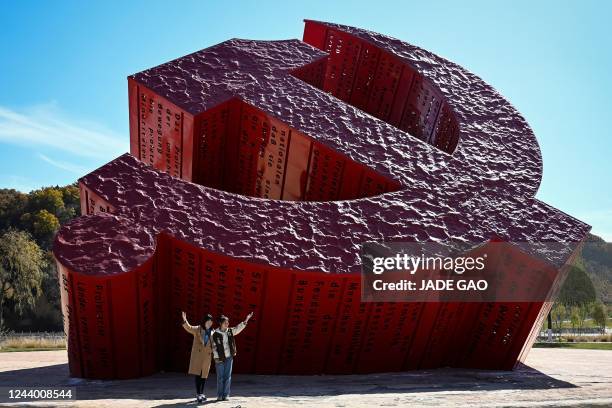 People for photos next to a Communist monument in Nanniwan in Yanan city, Chinas northwest Shaanxi province on October 16 on the first day of 20th...